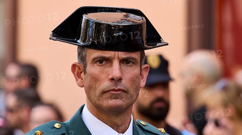 Man in green uniform wearing traditional hat at a street ceremony, Good Friday procession, Easter, UNESCO World Heritage Site, old town of San Cristobal de La Laguna, La Laguna, Tenerife, Canary Islands, Spain