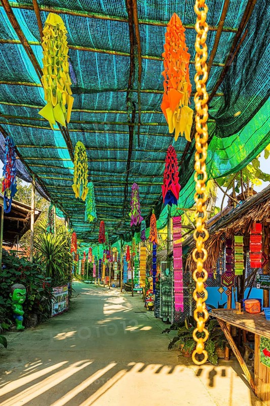 Colourful prayer flags hang in the entrance to Karen Long Neck Village, Chiang Mai, Thailand