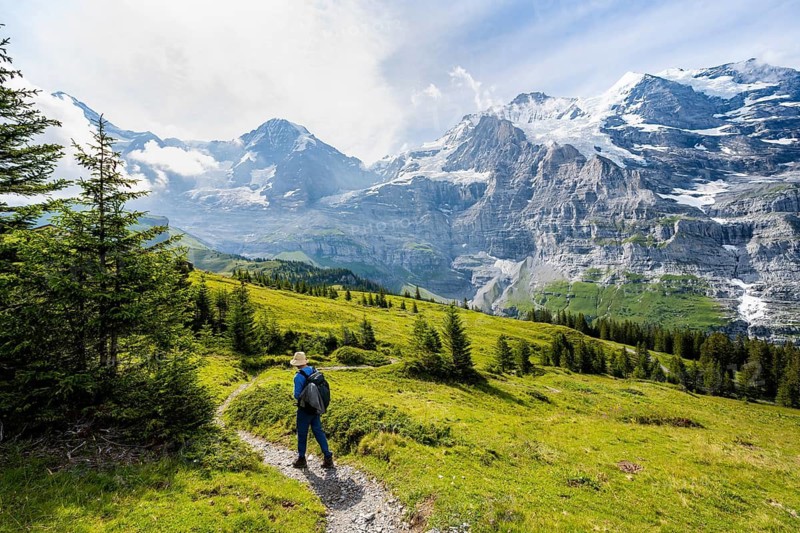 Hikers on a hiking trail on Mettlenalp, mountain panorama with peaks Eiger, Mönch and Jungfrau, Bernese Alps, Bernese Oberland, Switzerland