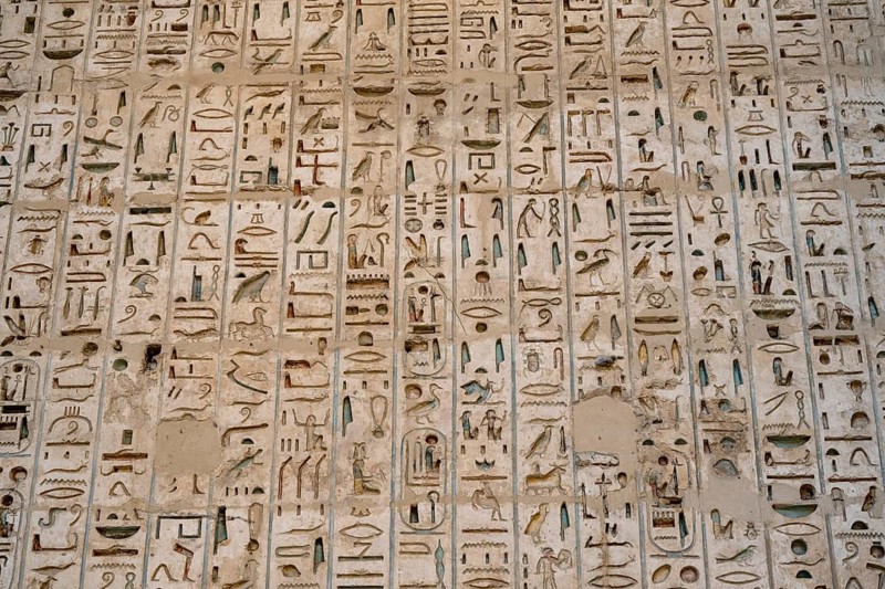 Close up details of the reliefs and hieroglyphs inside Medinat Habu, the ancient Egyptian Mortuary Temple of Ramesses III on the West Bank of The Nile, Luxor, Egypt