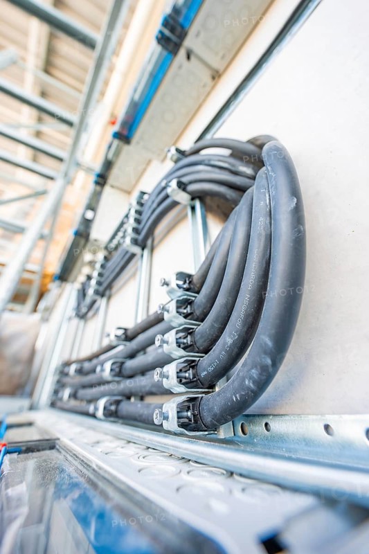 Densely strung black cables in an electrical system, mounted on metal, electrical system for PV system, industrial customers, Mühlacker, Germany