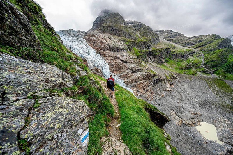 Mountaineers on a hiking trail, dramatic mountain landscape with Lower Arctic Sea glacier, Bernese Alps, Bernese Oberland, Switzerland