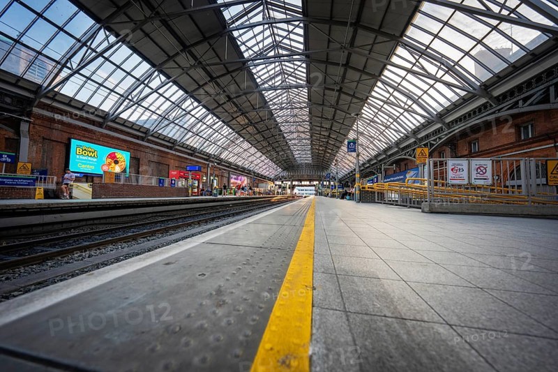 An empty train station with extensive canopy and tracks in an urban setting, Dublin, Ireland