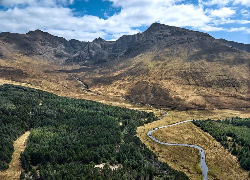 Aerial panoramic drone photo landscape of the Black Cuillins mountain chain with the tourist attraction of the fairy pools, Isle of Skye, Scotland, UK
