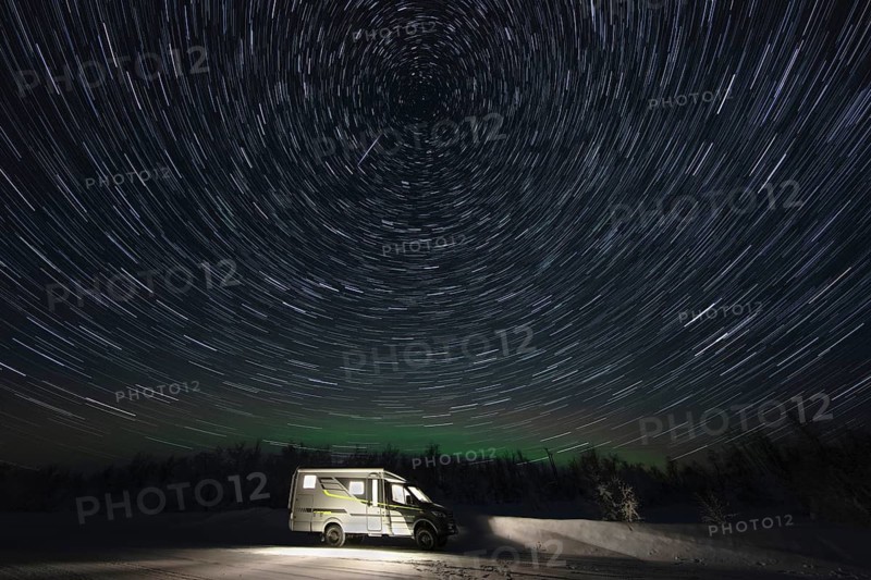 Motorhome in winter under a star track