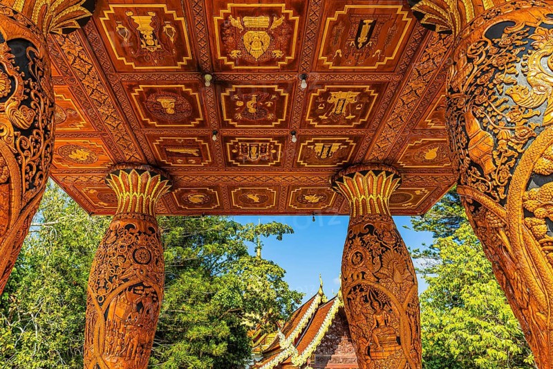 Decorated wooden ceiling of a pagoda supported by filigree carving columns, Wat Phra That Doi Suthep temple complex, Chiang Mai, Thailand