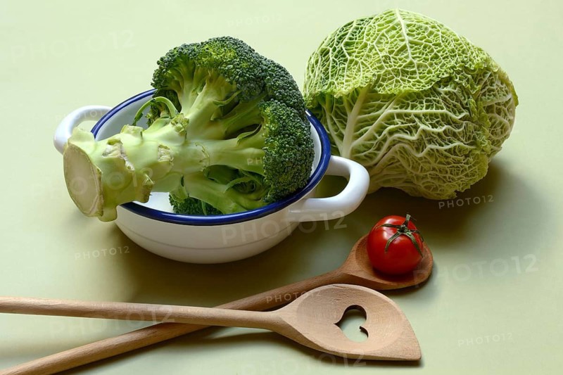Savoy cabbage and broccoli with cooking spoon