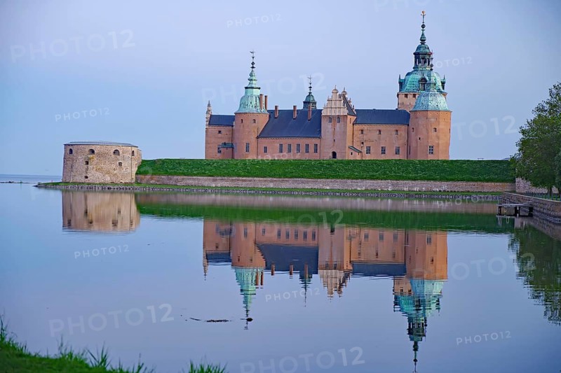 Historic castle at dawn reflected in calm water, Kalmar Slott, Kalmar, Kalmar Län, Sweden
