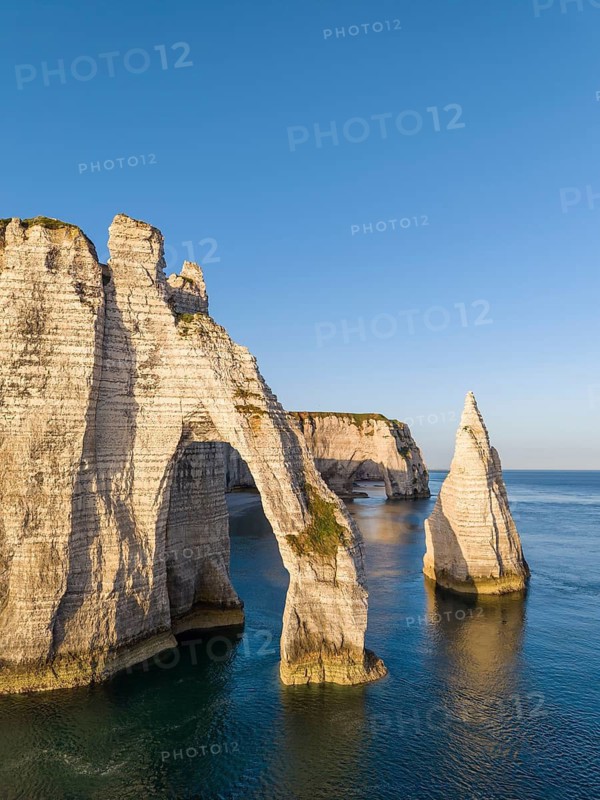 Aerial view of the Porte d'Aval rock formation shortly after sunrise, well-known landmark on the chalk coast with the distinctive Aiguille d'Étretat rock pin, behind it the La Manneporte rock gate, Étretat, Alabaster Coast, La Côte d'Albâtre, chalk cliffs, English Channel, Seine-Maritime, Normandy, France