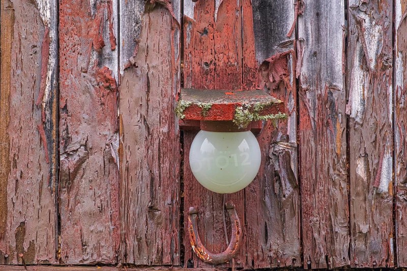 View of a lamp in a barn on a farm in the mountains of Gol in the rain, Halligdal, Buskerud, Norway