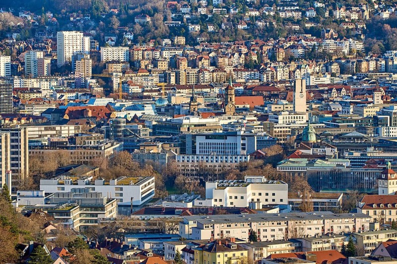 Panoramic view of Stuttgart city center in Germany during spring with warm golden evening light. Dense urban architecture, hills and residential districts captured from an elevated viewpoint, Stuttgart, Baden-Wuerttemberg, Germany