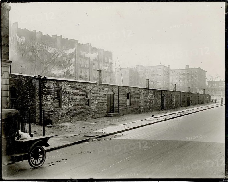 New York, Harlem, poverty, black residents, USA, deserted street with old brick houses in a foggy environment, 1910