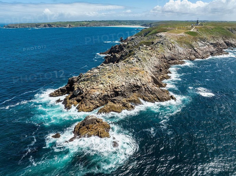 Aerial view of the Pointe du Raz headland on the stormy Breton coast with white ocean spray on the edges, Plogoff, Cap Sizun, Finistère department, Brittany region, France