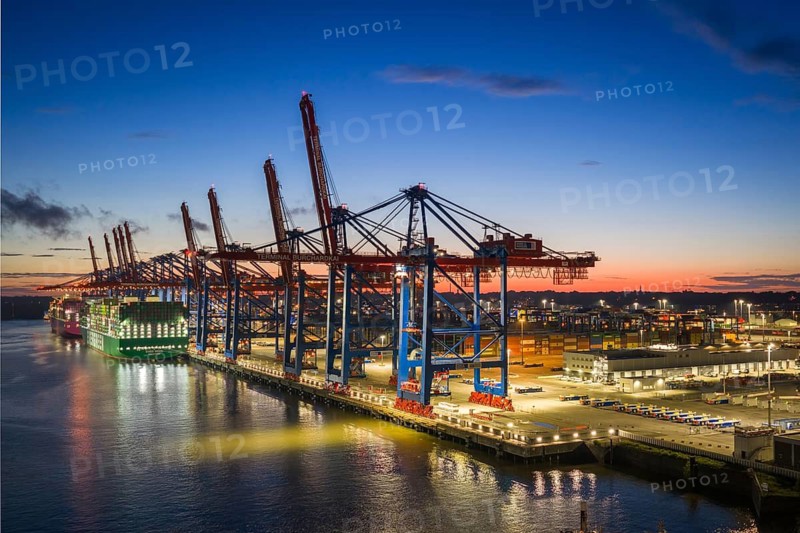 Aerial view at Waltershof harbour during the Blue Hour at Container Terminal Burchardkai (CTB) with the brightly lit Ever Meed (Evergreen), Hamburg, Germany
