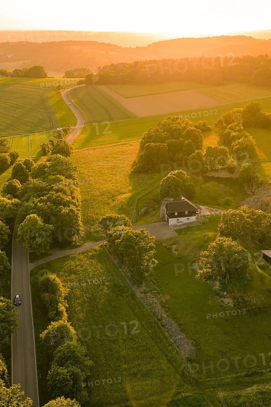 Single building surrounded by fields and trees in golden sunlight, Gechingen, Hecken and Gäu region, Landreis Calw, Germany