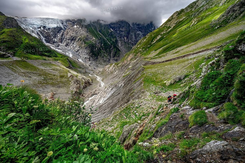 Dramatic mountain landscape covered in clouds with Grindelwald-Fiescherfirn glacier, Bernese Alps, Bernese Oberland, Switzerland