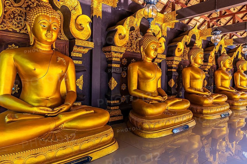 Seated, gilded Buddha statues in the Buddhist temple Wat Phra That Don Phra Chan, near Lampang, Lampang Province, Thailand