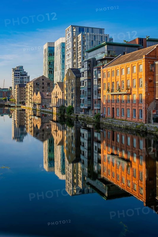 Buildings are picturesquely reflected in the calm waters of a modern cityscape, Dublin, Ireland