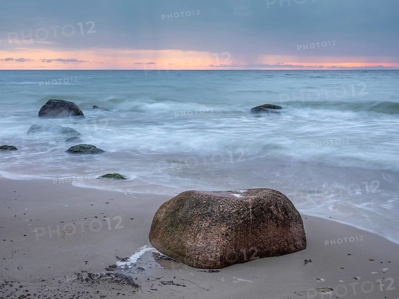 Morning atmosphere on the Baltic Sea, large boulders on the beach, dark clouds and rain showers on the horizon, Cape Arkona, Rügen Island, Mecklenburg-Western Pomerania, Germany