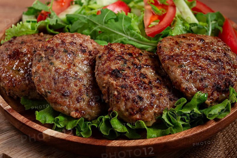 Fried cutlets, mixed minced meat, with vegetable salad, homemade, top view, no people