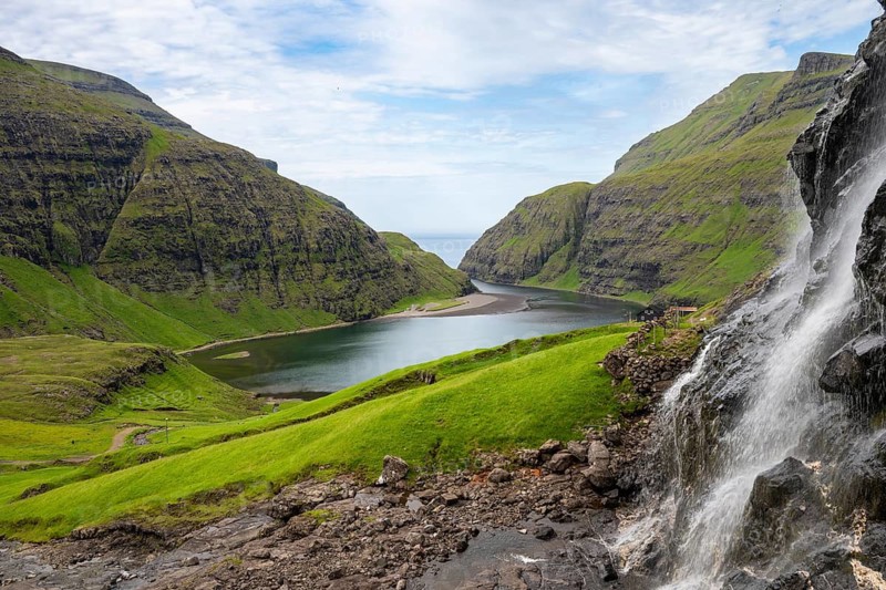 View of waterfall, meadows and fjord of Saksun, Streymoy Island, Faroe Islands, Denmark