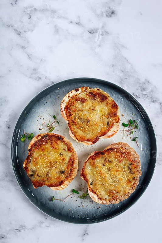 Scallop shells, stuffed, baked with cheese, in the oven, julienne with scallops