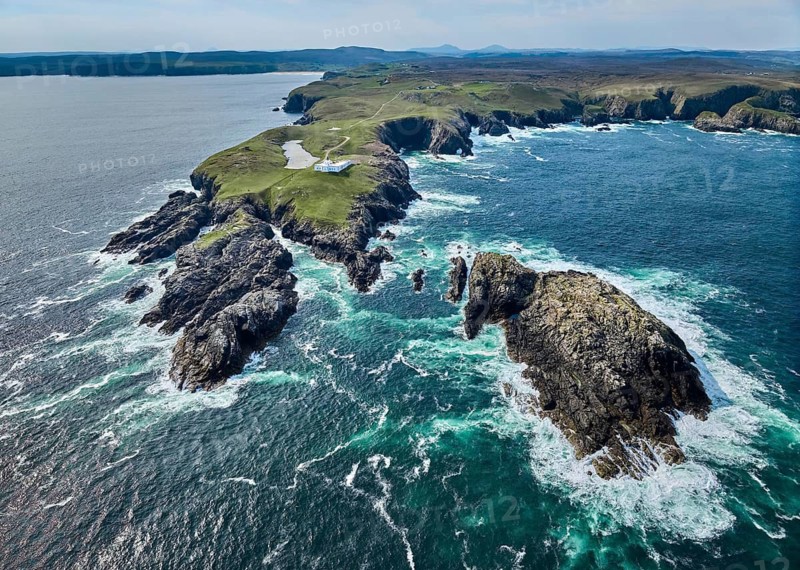 Aerial drone photo of Iighthouse on the rocky cliffs and heavy atlantic ocean surf, Strathy point, northern Scotland, UK