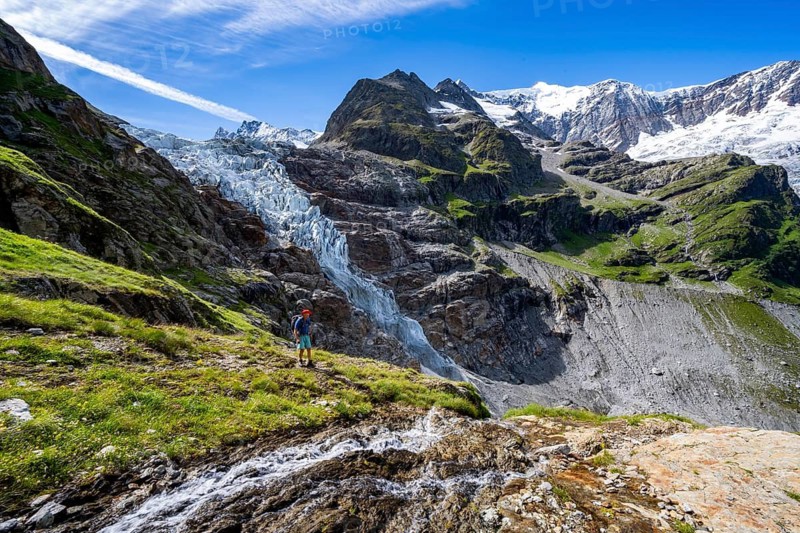 Mountaineers in front of mountain panorama, picturesque high-alpine mountain landscape with Lower Arctic Sea glacier and Grindelwald-Fiescherfirn glacier, hiking to Schreckhornhütte, Bernese Oberland, Switzerland