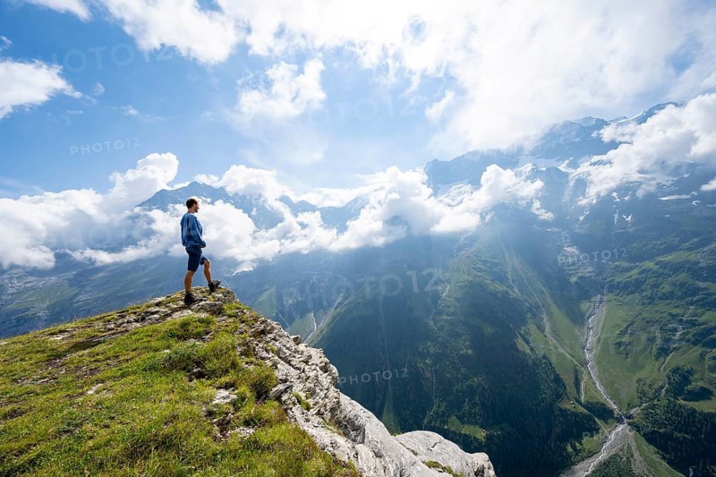 Mountaineers in front of picturesque mountain scenery at the summit of Tanzbödeli, Bernese Alps, Bernese Oberland, Switzerland