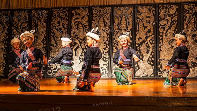Young Thai women in traditional dress showing a traditional dance, Old Chiang Mai Cultural Center, Chiang Mai, Thailand
