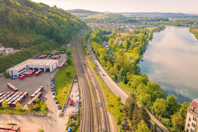 View of train station, river and countryside, green trees and extensive fields in summer, electrification of the Hochrheinbahn, conversion of the station, Waldshut, Tiengen, Germany