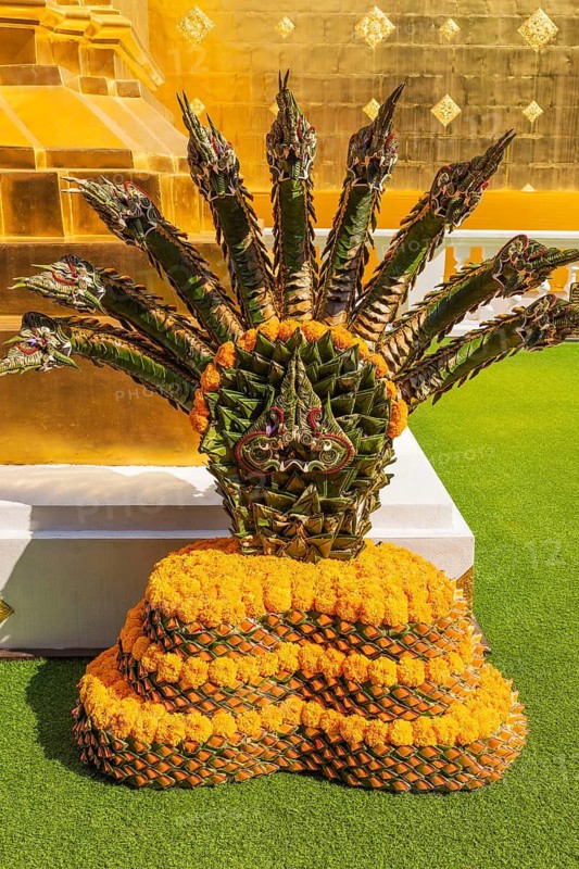 Green and orange intricately woven floral decoration in the Wat Phra Singh Buddhist temple complex, Chiang Mai Old City Center, Chiang Mai Province, Thailand