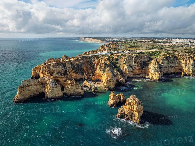 Aerial view of Ponte da Piedade in Lagos, Algarve, Portugal, with golden cliffs, ocean surf and sea stacks