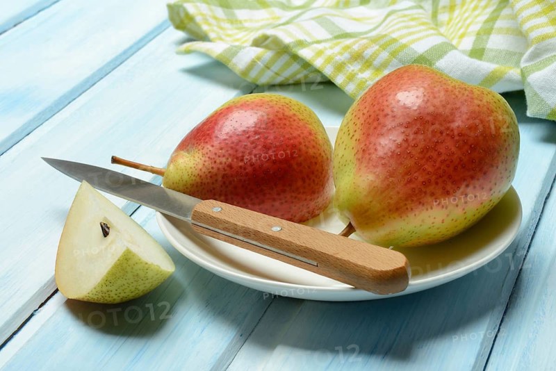 Pears on plate, cut with knife