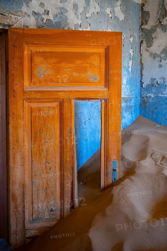 Interior view, door and house full of sand, former diamond mining town, Namib Desert, Kolmanskop, Karas, Namibia