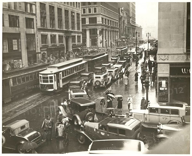 New York, 42nd Street, rain, traffic, streetcar, shops, department stores, Manhattan, USA, busy city street in the rain with heavy traffic and many passers-by, around 1935