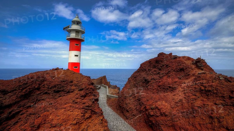 Punta de Teno, lighthouse on rocky cliffs with rocky path, blue sky and sea in the background, Masca, Barranco de Masca, canyon, Teno, Teno Mountains, northwestern Tenerife, Tenerife, Canary Islands, Spain