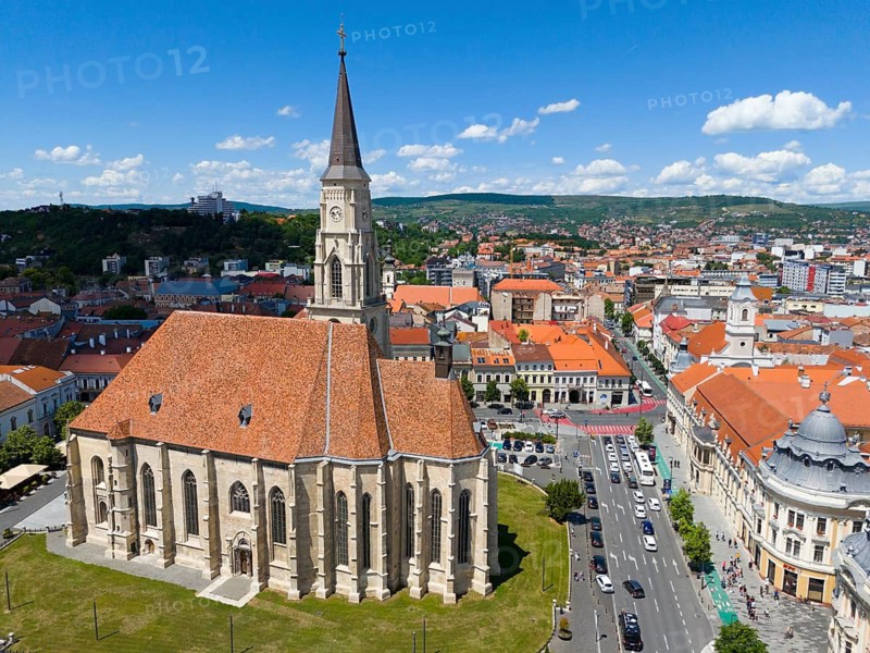 Neo-Gothic church with red tile roof and high tower, surrounded by urban infrastructure, aerial view, St. Michael's Church in Cluj, Gothic hall church, Cluj-Napoca, Cluj, Transylvania, Romania