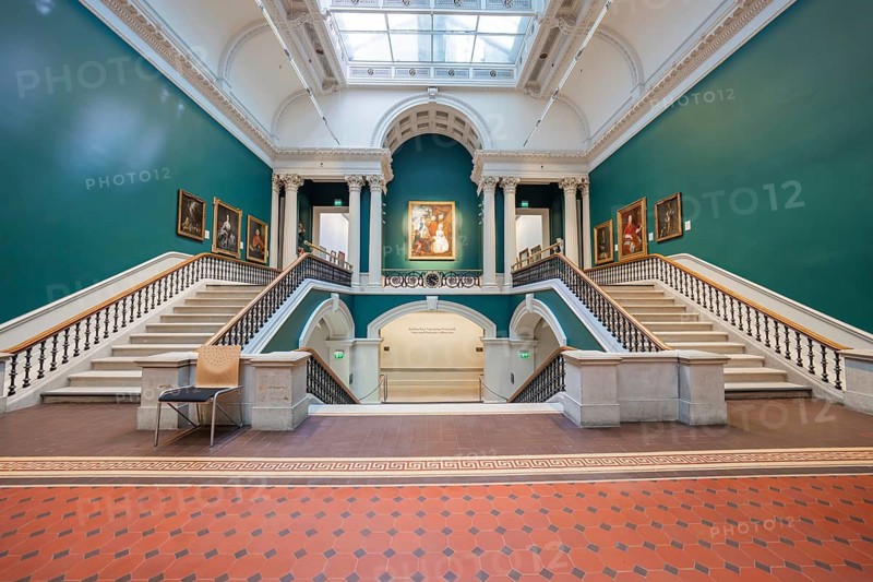 Large staircase in an art gallery with green walls and paintings. Symmetrical architecture, National Gallery of Ireland, Dublin, Ireland