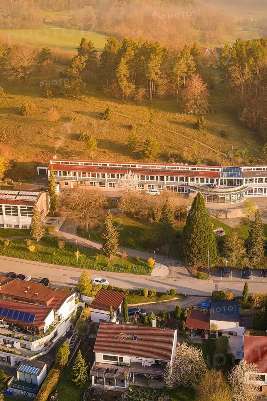 Aerial view of buildings on a hill surrounded by green trees and roads, Deufringen, Aidlingen, Heckengäu region, Böblingen district, Germany