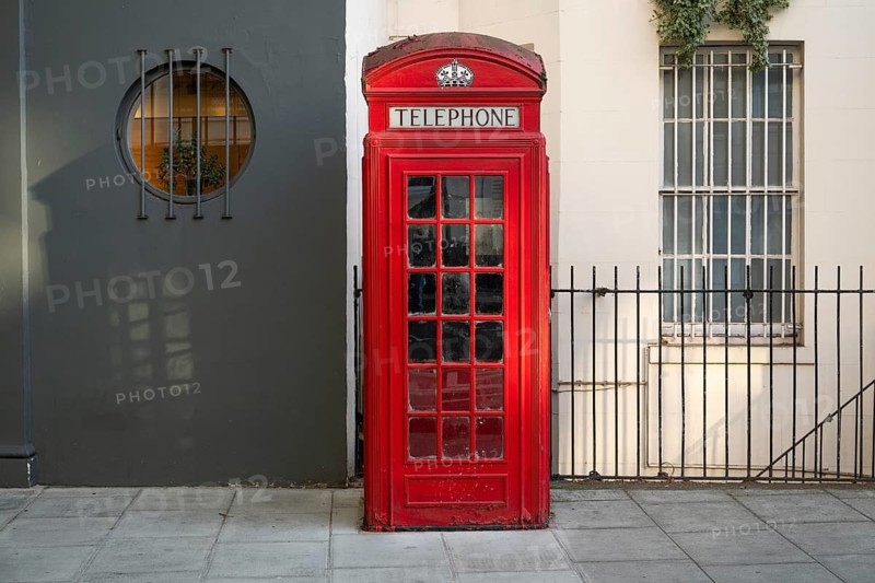 A classic red telephone box stands on a street, Westminster, London, Great Britain, England, Great Britain