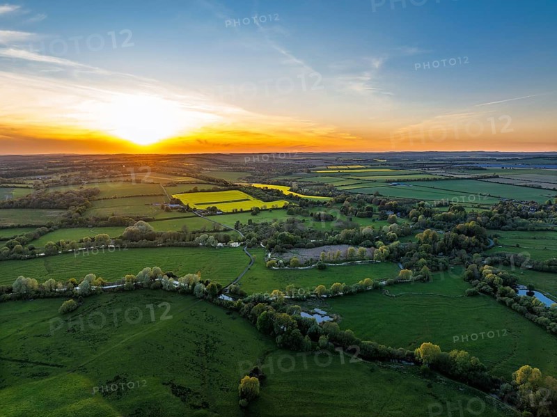 Sunset of Fields and Farms over Horsebridge nad Stockbridge from a drone, Hampshire, England, United Kingdom