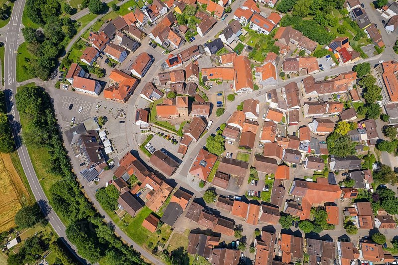 Aerial view of a village with houses close together with red roofs surrounded by green landscape, Ötisheim, Enzkreis, Germany