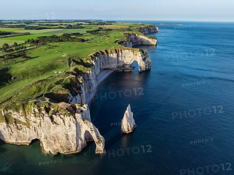 Aerial view of the Porte d'Aval rock formation with the free-standing Aiguille d'Étretat rock pin in the morning sun, well-known sights and natural beauty on the chalk coast with the distinctive rock pin, on the right the La Manneporte rock gate and the distinctive Pointe de la Courtine ledge, then Pointe du Fourquet, right on the cliffs of the Golf d'Étretat, Étretat golf course founded in 1908, Alabaster Coast, La Côte d'Albâtre, chalk cliffs, English Channel, Seine-Maritime, Normandy, France