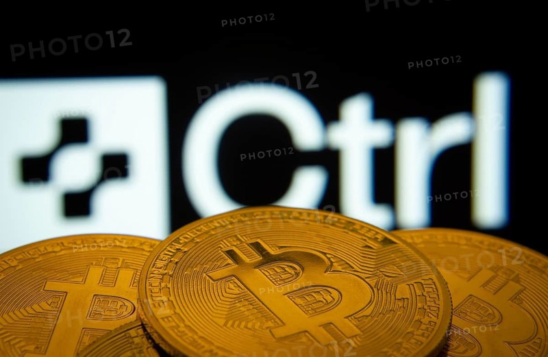 Dhaka, Bangladesh- 27 March 2025: Close-up of Bitcoin coins with the Ctrl Wallet logo visible on a screen in the background