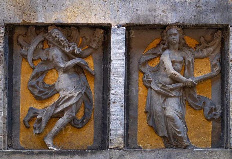 Stone relief over an entrance door, historic Böttcherstraße in the old town of the Hanseatic city of Bremen from the 1920s, example of clinker expressionist architecture, brick architecture, old man with long beard and scythe, young woman with torch, popular tourist destination, Germany