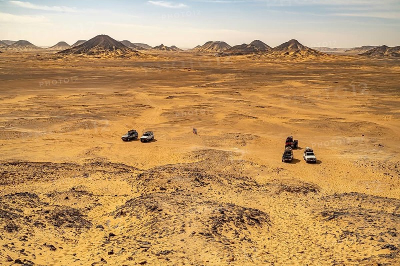 Off-road vehicle with tourists in the Black Desert in the Egyptian part of the Libyan Desert, Egypt
