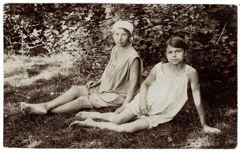 Bathing, swimwear, girls, leisure, fun, summer, Two girls in simple summer dresses sitting in the shade of a bush, around 1920