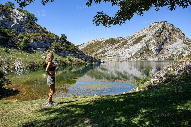 Middle aged woman contemplates the Ercina lake, Covadonga lakes ensemble, Picos de Europa National Park, principality of Asturias, Spain
