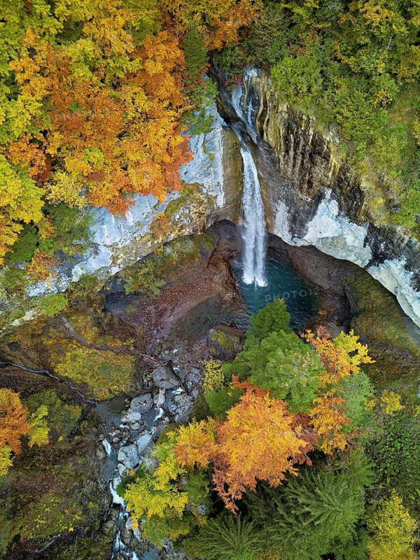 Aerial view of Berglistüber waterfall in autumn-colored surroundings, Linthal, Klausenpass, Canton of Glarus, Switzerland